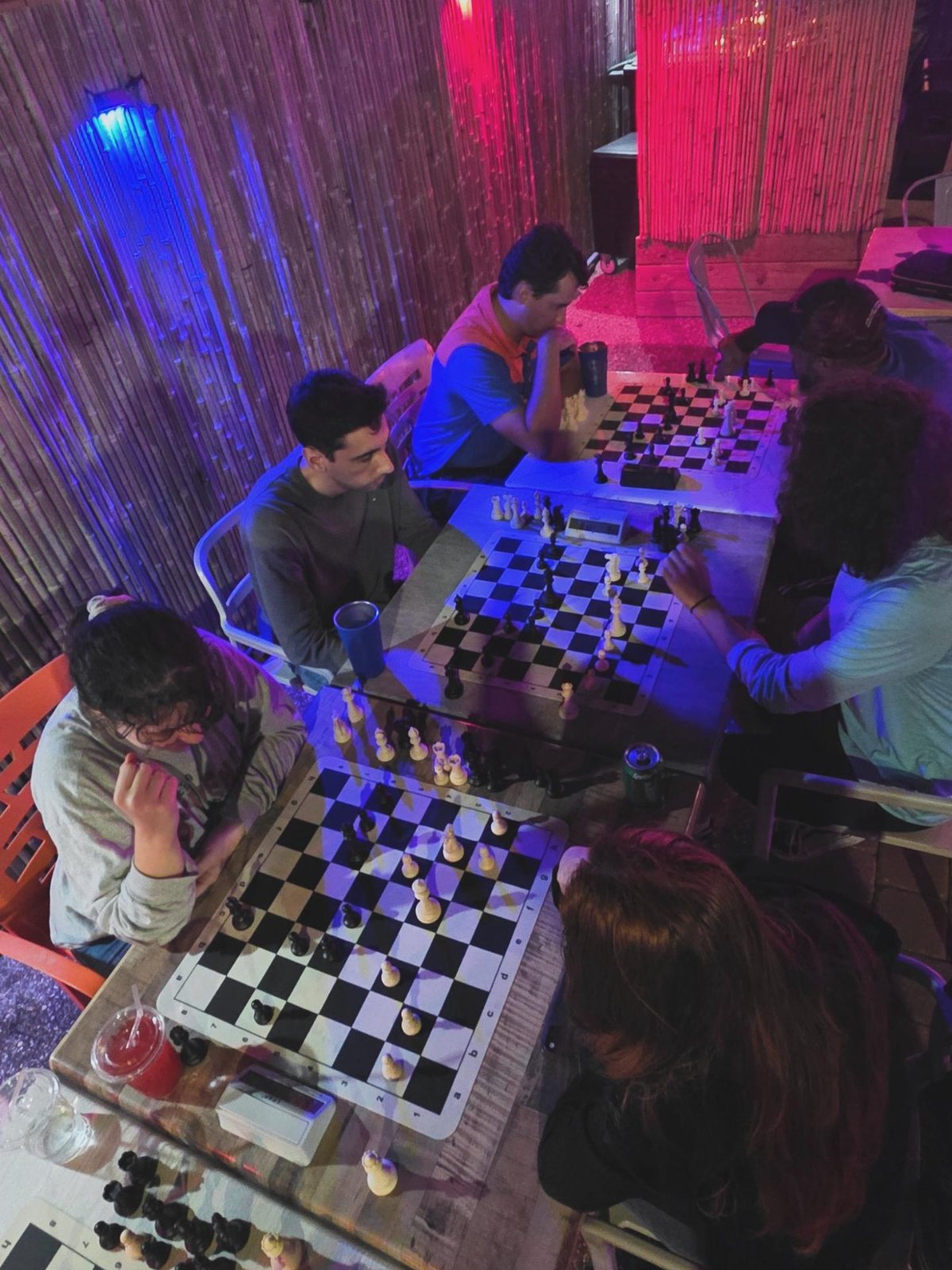 Study night on the patio at Kava Social Club: players around the boards after the Karpov lesson