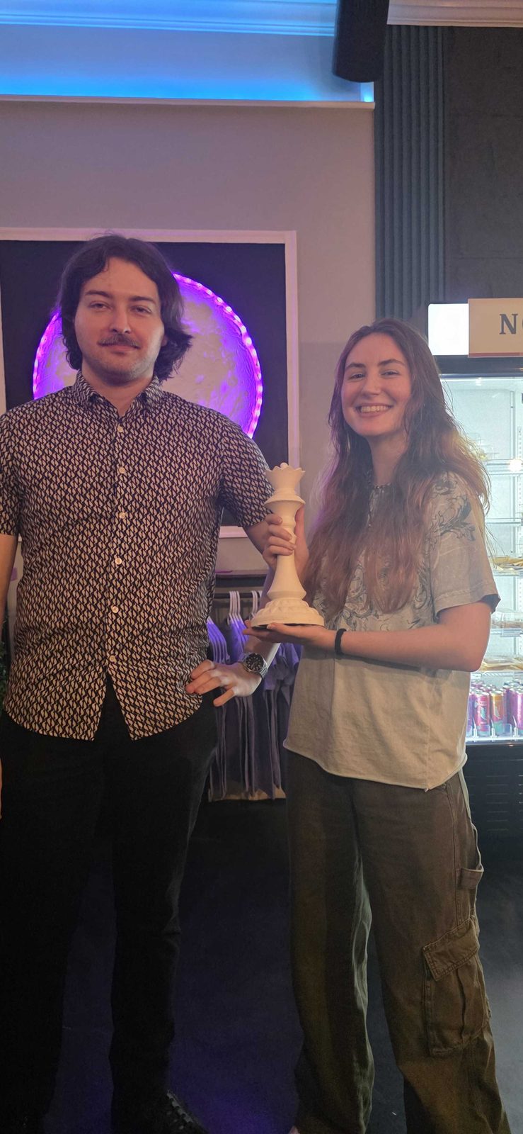 Maddie holding the queen trophy for Best Female Player