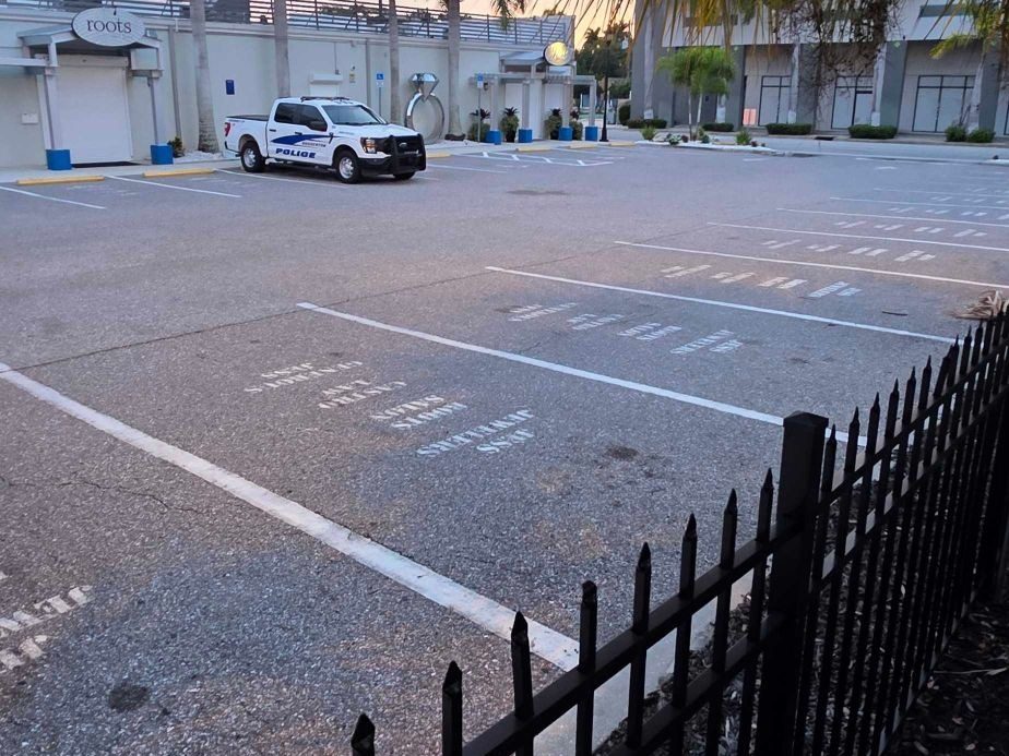 The small lot behind Jess Jewelers, with business names painted on the reserved parking spaces